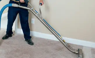 Professional operating a liquid removal machine on a carpeted floor in Allentown, PA